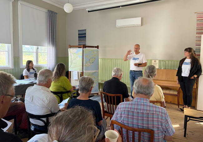 Två personer håller en presentation inför publik.