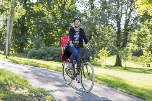 En kvinna cyklar på en cykelväg.